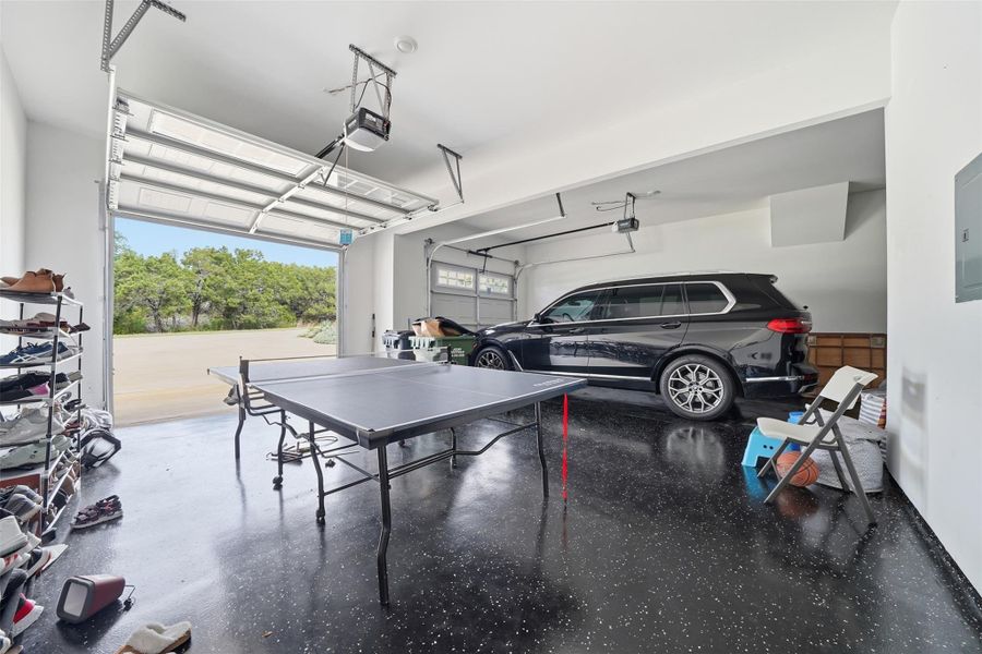 The garage features a polished, speckled floor and an overhead door providing direct access to the exterior