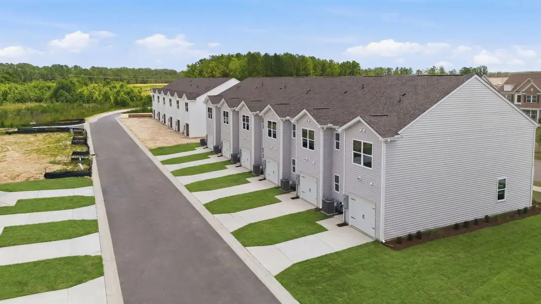 Front exterior of a new home in Clock Road Townhomes, New Bern, NC, highlighting curb appeal (Image 1). Front exterior of a new home in Clock Road Townhomes, New Bern, NC, highlighting curb appeal (Image 1).