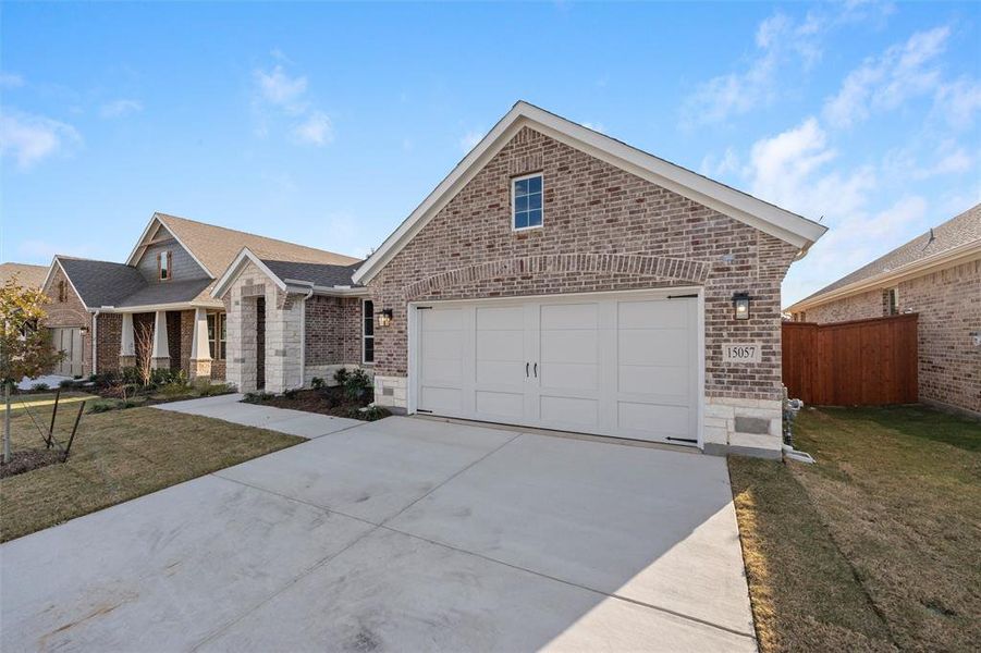 View of front of home with brick siding, driveway, a garage, and covered porch View of front of home with brick siding, driveway, a garage, and covered porch