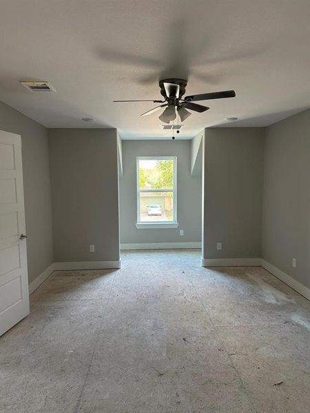 Empty room featuring baseboards and a ceiling fan