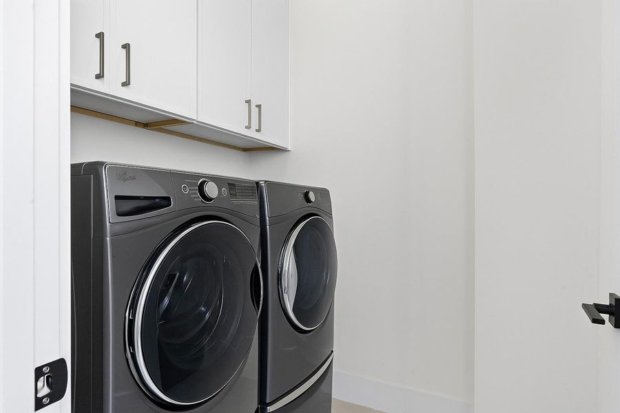 Laundry room conveniently next to the primary bedroom - Your view from the dining room to the living room with access to your balcony. -  Come tour our furnished model home open Saturday & SundayEstimated completion November 30, 2025.