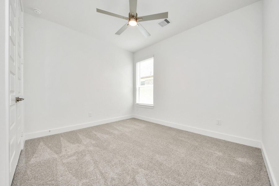 Secondary bedroom features plush carpeting, large windows that let in plenty of natural light, bright paint, and spacious closets. Secondary bedroom features plush carpeting, large windows that let in plenty of natural light, bright paint, and spacious closets.