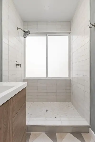 Full bathroom featuring tiled shower