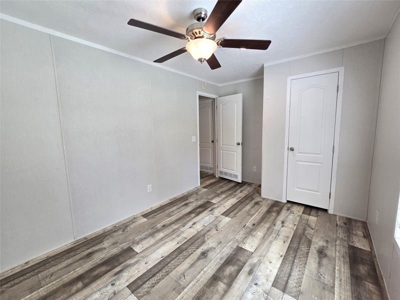 This inviting third bedroom features sleek wood-look flooring, a modern ceiling fan, and ample natural light, creating a comfortable and stylish retreat. This inviting third bedroom features sleek wood-look flooring, a modern ceiling fan, and ample natural light, creating a comfortable and stylish retreat.