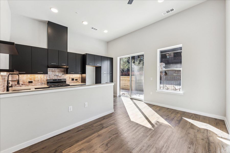 High ceilings and sun-filled interiors define this contemporary space, featuring a modern kitchen. High ceilings and sun-filled interiors define this contemporary space, featuring a modern kitchen.