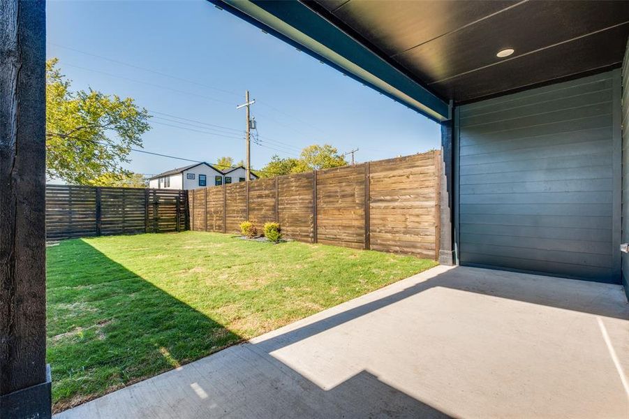 Fenced backyard with a patio