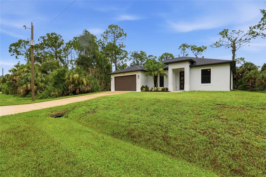 Front exterior of a new home in , Port Charlotte, FL, highlighting curb appeal (Image 22).