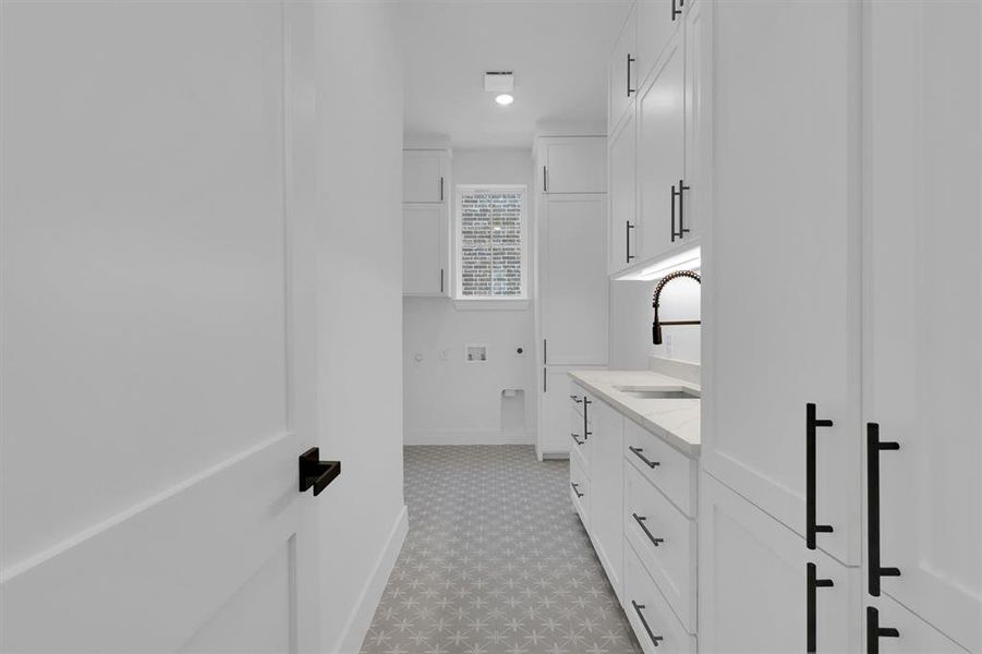 Bathroom featuring tile patterned floors and vanity Bathroom featuring tile patterned floors and vanity