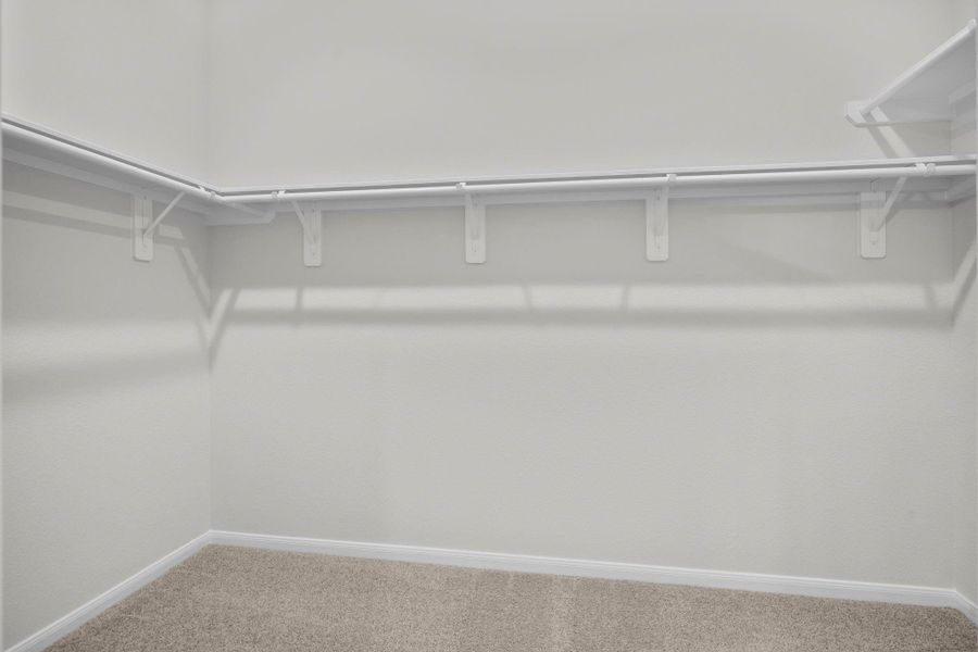 The spacious walk-in closet provides ample storage with multiple hanging areas and shelving. Its thoughtful design keeps clothing and accessories organized while maintaining a clean, open feel. The spacious walk-in closet provides ample storage with multiple hanging areas and shelving. Its thoughtful design keeps clothing and accessories organized while maintaining a clean, open feel.