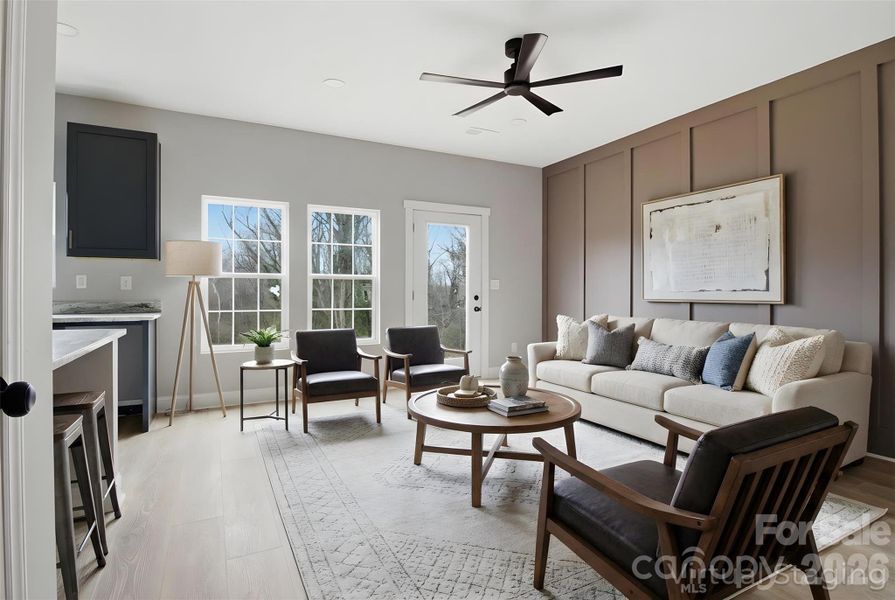 Walking into the living & dining room area on the main floor (virtually staged/enhanced).