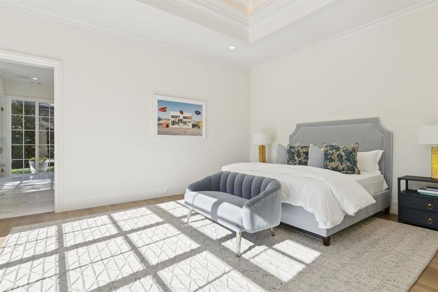 Bedroom with light wood-style floors, crown molding, recessed lighting, and ensuite bathroom
