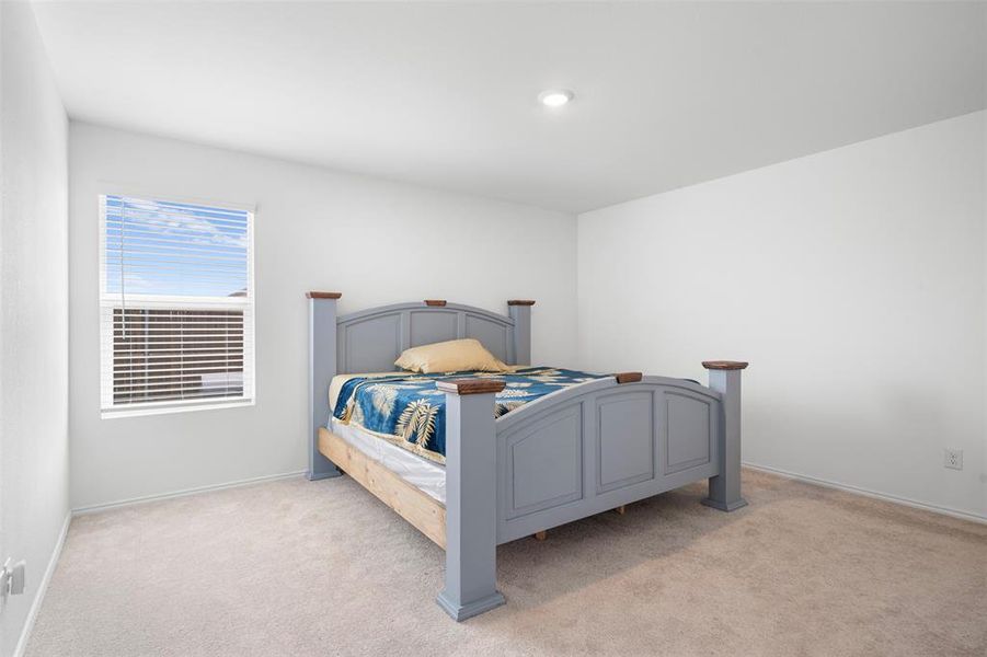 Bedroom featuring light colored carpet Bedroom featuring light colored carpet