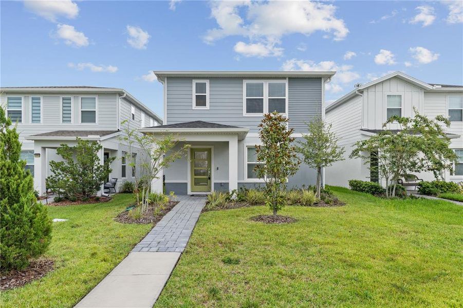 Front exterior of a new home in EverBe, Orlando, FL, highlighting curb appeal (Image 21).
