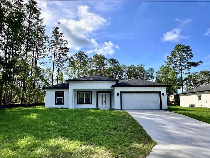 Front exterior of a new home in , Citrus Springs, FL, highlighting curb appeal (Image 17). Front exterior of a new home in , Citrus Springs, FL, highlighting curb appeal (Image 17).