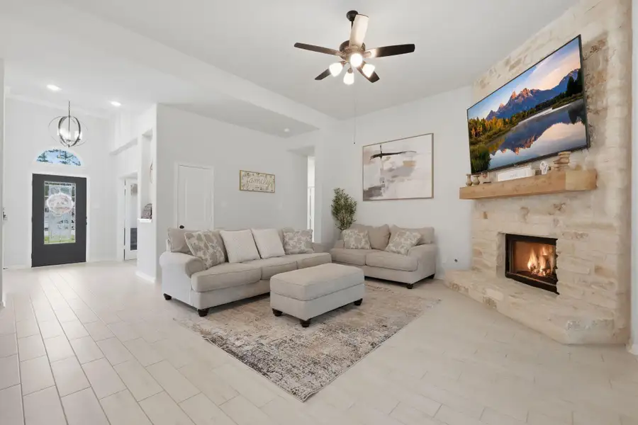 Bright, open living room with a cozy fireplace, perfect for relaxing or gathering with family.