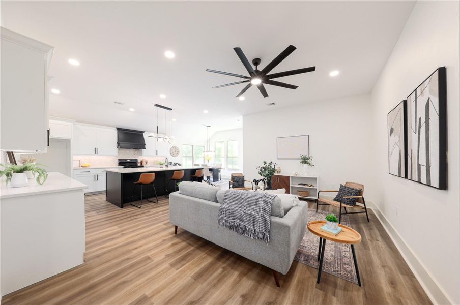 Living area with light wood-style floors, recessed lighting, and ceiling fan