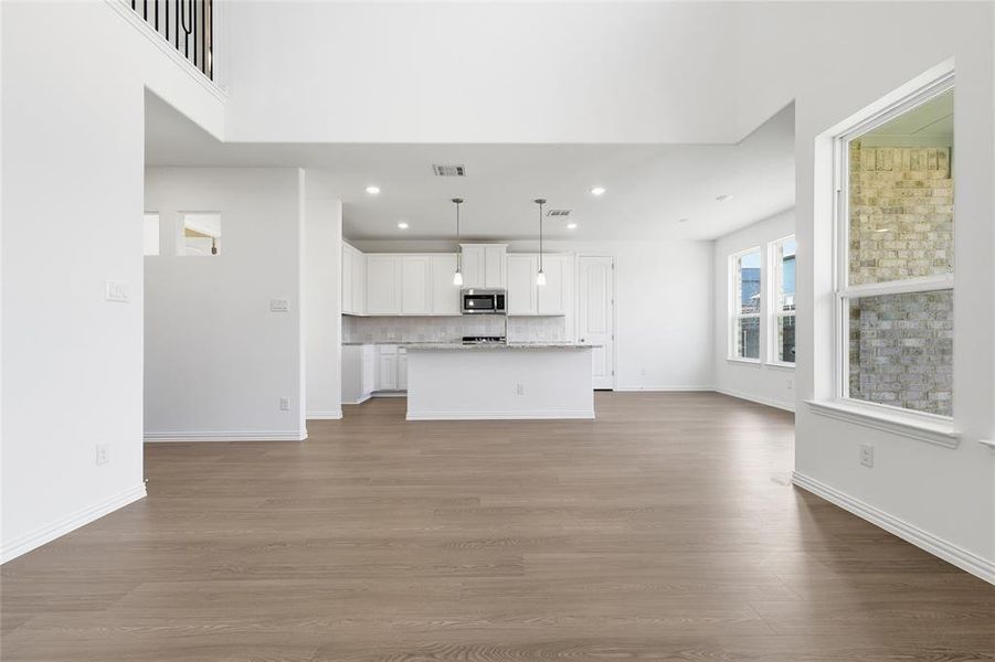 Unfurnished living room with recessed lighting and dark wood-style floors