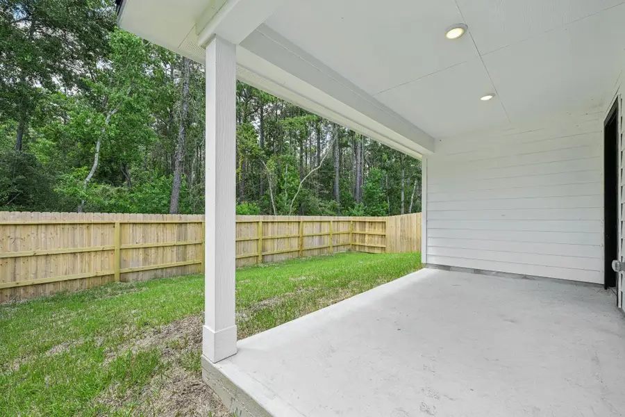 Exterior details and patio area of a home in Landing Meadows - Traditional Series, New Caney (Image 21).