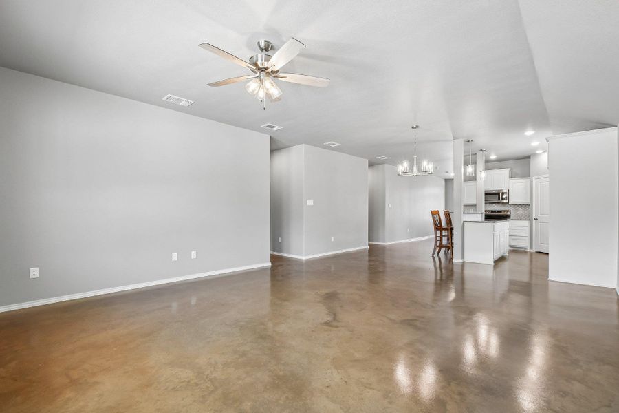 An open concept living area transitions seamlessly into a well-appointed kitchen. An open concept living area transitions seamlessly into a well-appointed kitchen.