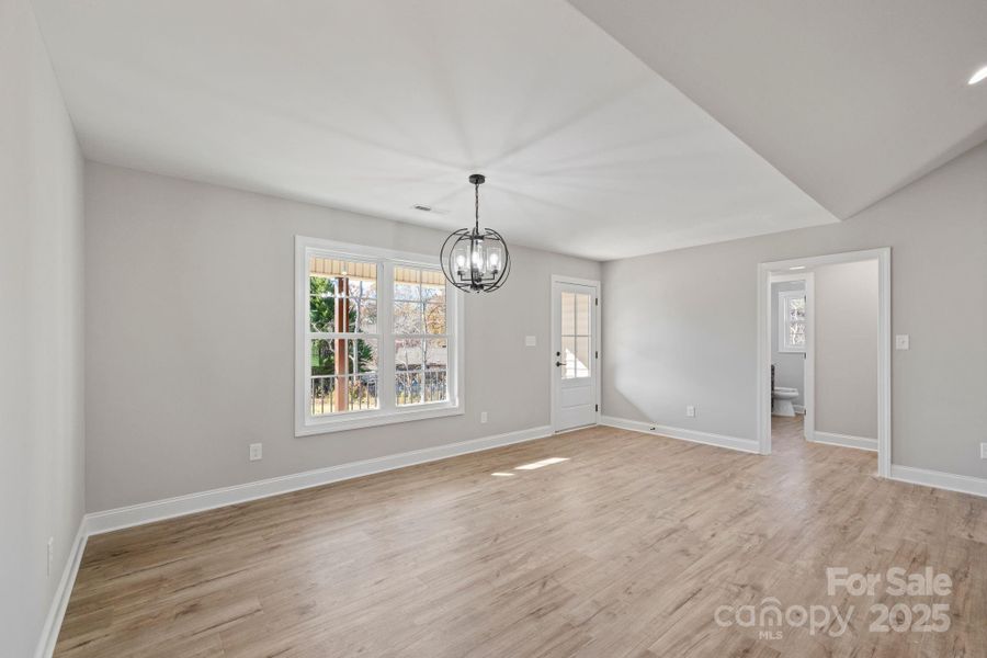 Bright dining area with large windows and a modern light fixture, conveniently located just off the front entrance—ideal for everyday meals and gatherings. Bright dining area with large windows and a modern light fixture, conveniently located just off the front entrance—ideal for everyday meals and gatherings.