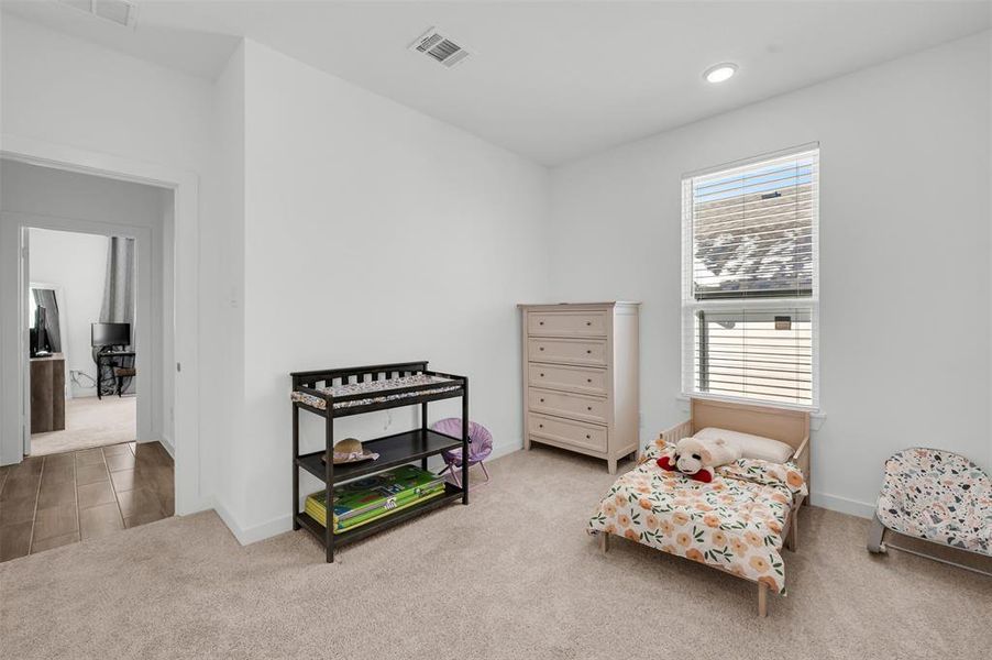 Living area featuring light carpet