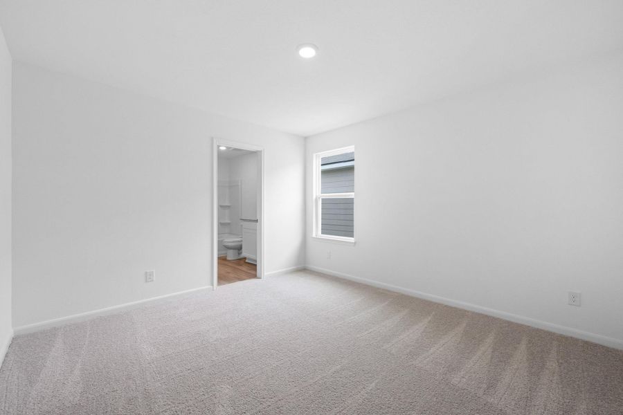 Unfurnished room featuring baseboards and light colored carpet