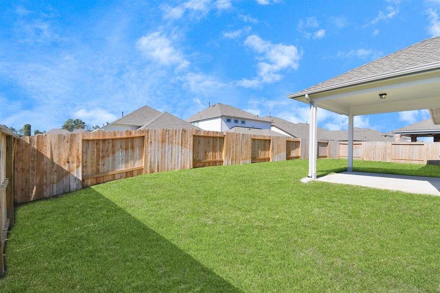 Come and see this spacious backyard with its beautiful covered patio!