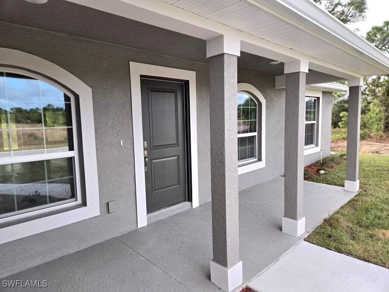 Front exterior of a new home in Lehigh Acres, Lehigh Acres, FL, highlighting curb appeal (Image 10).