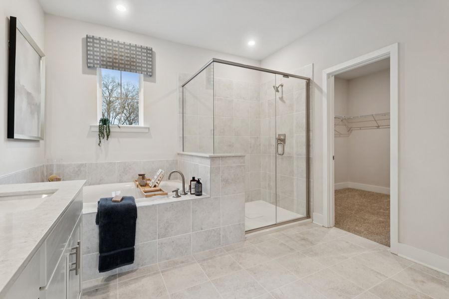 A bathroom with a shower and sink.
