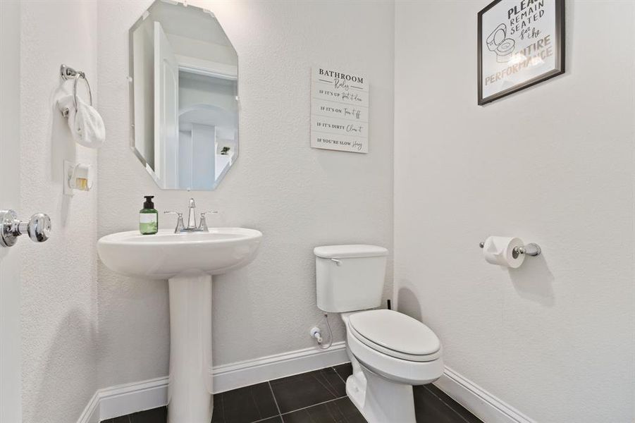 Bathroom featuring tile flooring and toilet