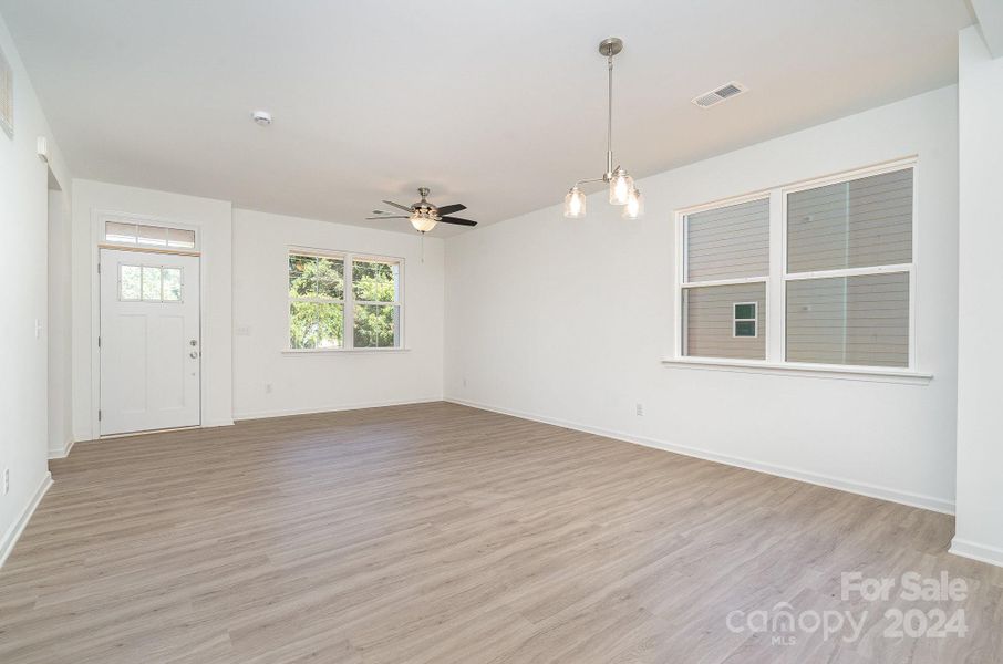 Representative Photo. Living room into dining area