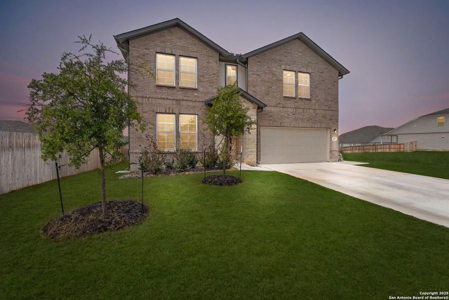 Front exterior of a new home in Saddle Creek Ranch, Cibolo, TX, highlighting curb appeal (Image 23). Front exterior of a new home in Saddle Creek Ranch, Cibolo, TX, highlighting curb appeal (Image 23).