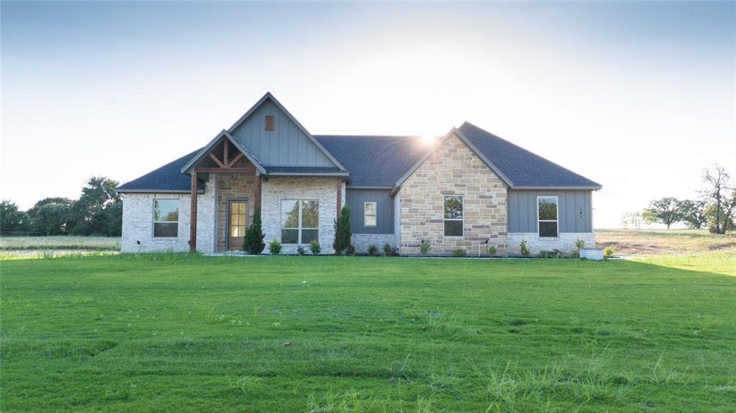 Front exterior of a new home in , Poolville, TX, highlighting curb appeal (Image 12).
