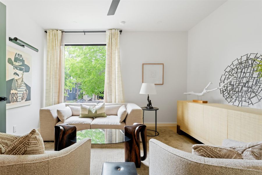 Living room with a ceiling fan and wood finished floors