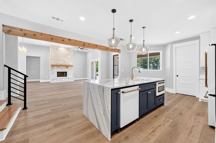 The centerpiece of the gourmet kitchen is the spectacular island, highlighted by a stunning waterfall edge. An intergraded microwave drawer, and three elegant glass pendent lights. The centerpiece of the gourmet kitchen is the spectacular island, highlighted by a stunning waterfall edge. An intergraded microwave drawer, and three elegant glass pendent lights.
