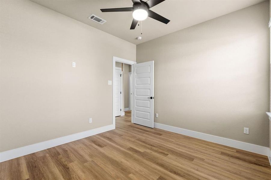 Bedroom #1 Upstairs. Spacious room featuring wood-finish flooring, light neutral wall tones, and white baseboards