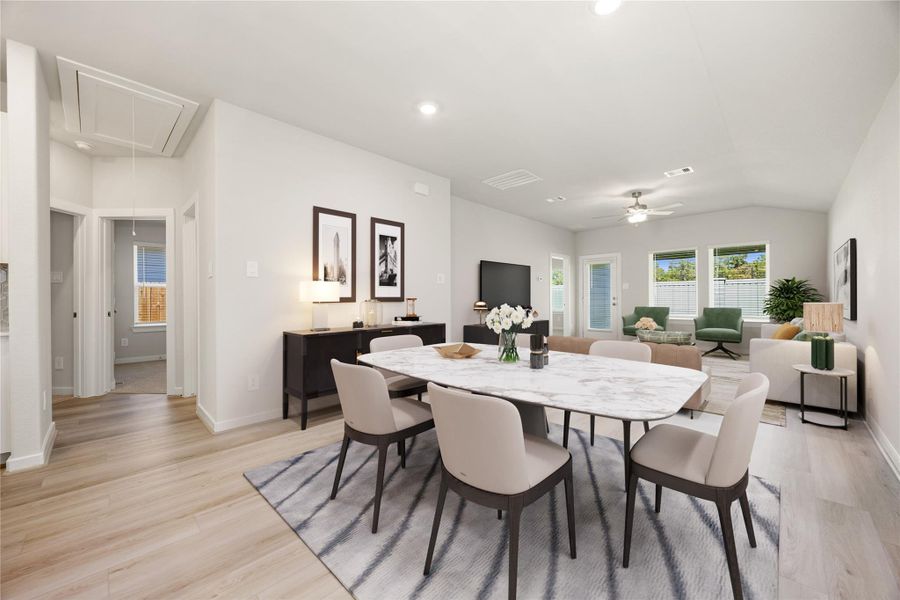 This open-concept layout connects the dining and living areas seamlessly, filled with natural light and modern finishes. Luxury vinyl plank flooring and soft neutral tones create an inviting space perfect for gathering and relaxing in comfort.