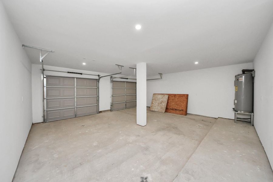 This spacious garage features two bays with automatic doors and ample lighting. It offers plenty of storage or workshop potential. This spacious garage features two bays with automatic doors and ample lighting. It offers plenty of storage or workshop potential.
