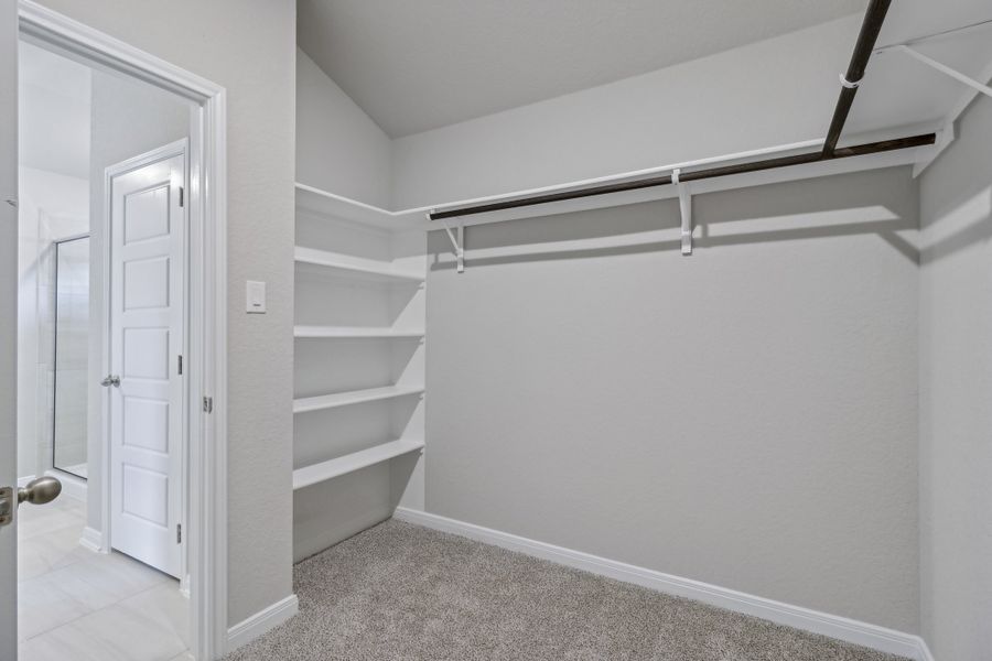 Primary suite walk-in closet in the Allen floorplan at a Meritage Homes community. Primary suite walk-in closet in the Allen floorplan at a Meritage Homes community.