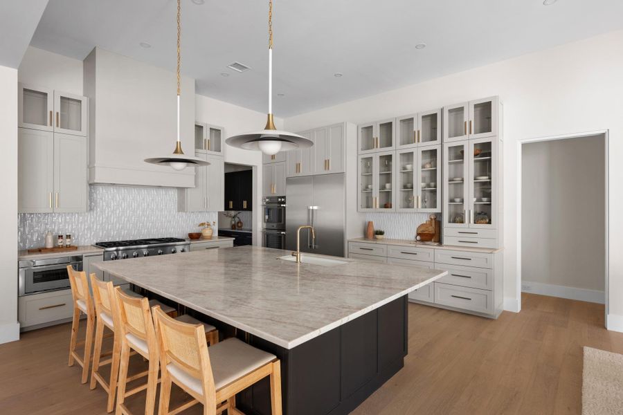 Architectural symmetry and custom cabinetry define a kitchen that is as highly functional as it is visually spectacular