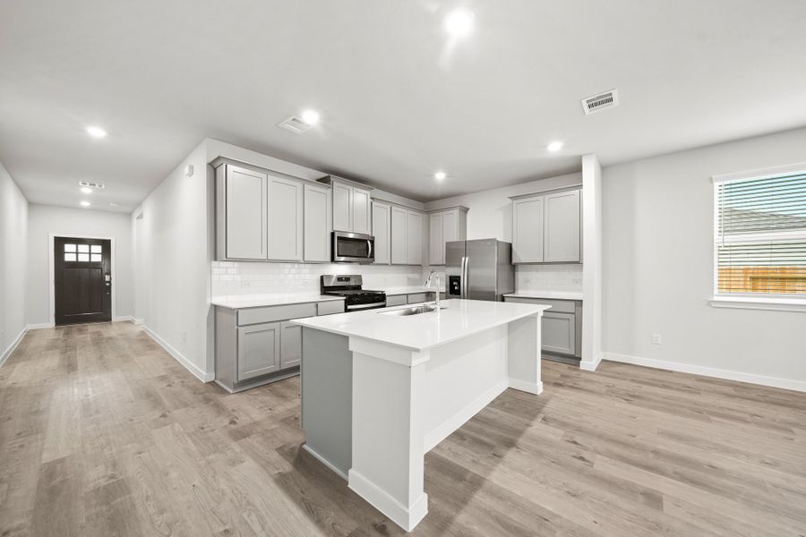 A kitchen with white cabinets.