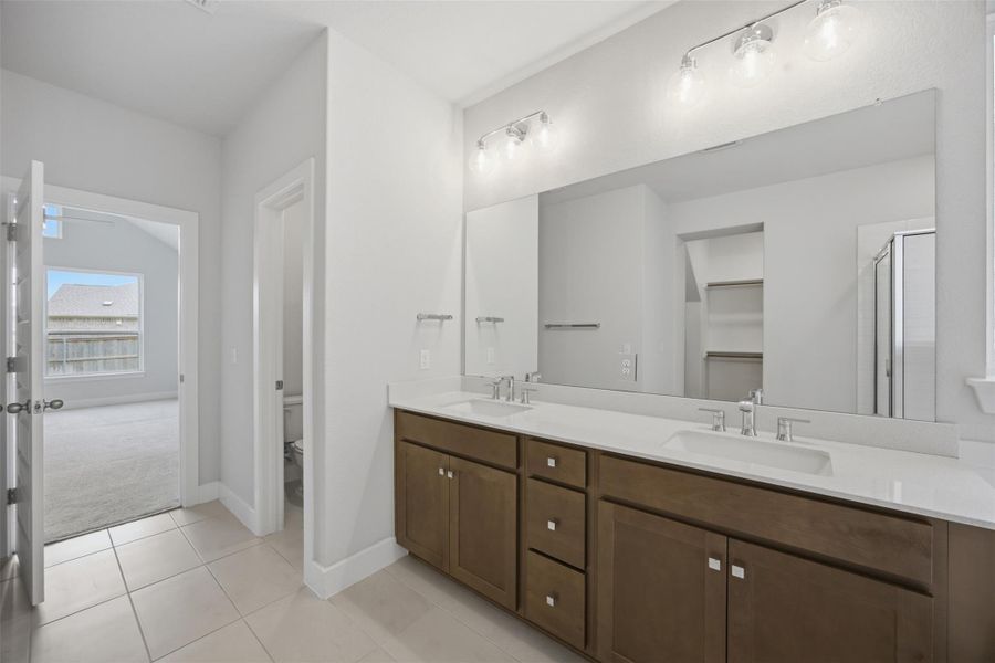 Double vanity with ample counter space creates a serene and practical start to your day.