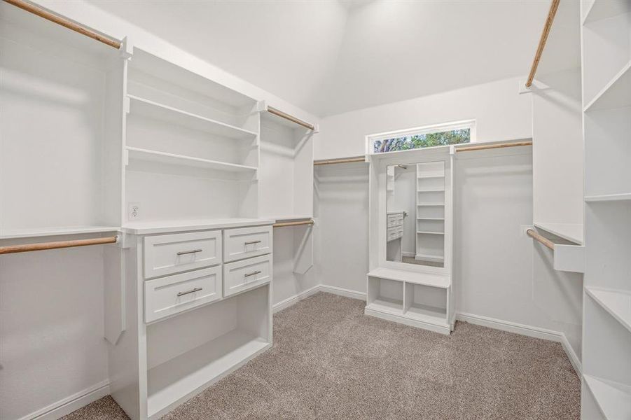 Walk in closet featuring light colored carpet Walk in closet featuring light colored carpet