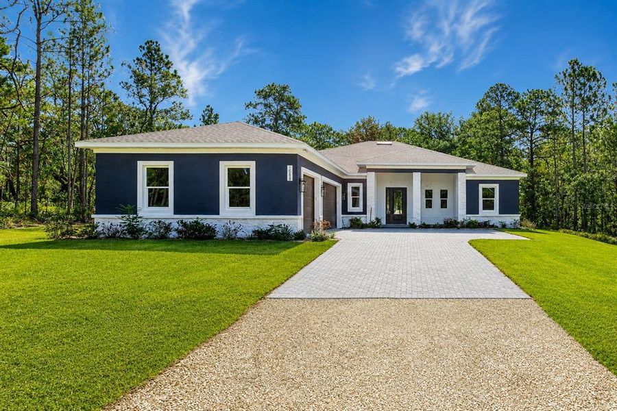 Front exterior of a new home in , Weeki Wachee, FL, highlighting curb appeal (Image 36).