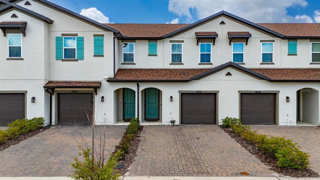 Front exterior of a new home in , Kissimmee, FL, highlighting curb appeal (Image 1).