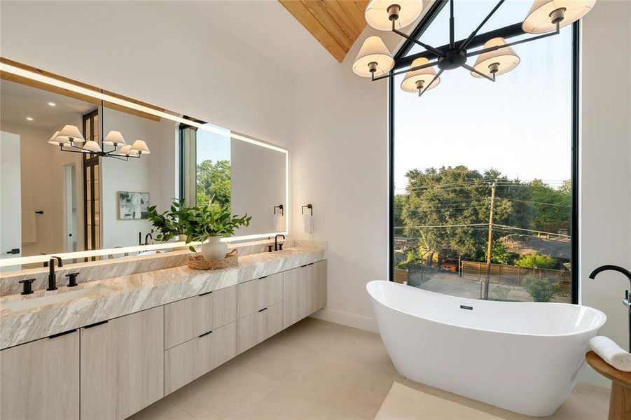 Freestanding soaking tub with a full-height window Freestanding soaking tub with a full-height window