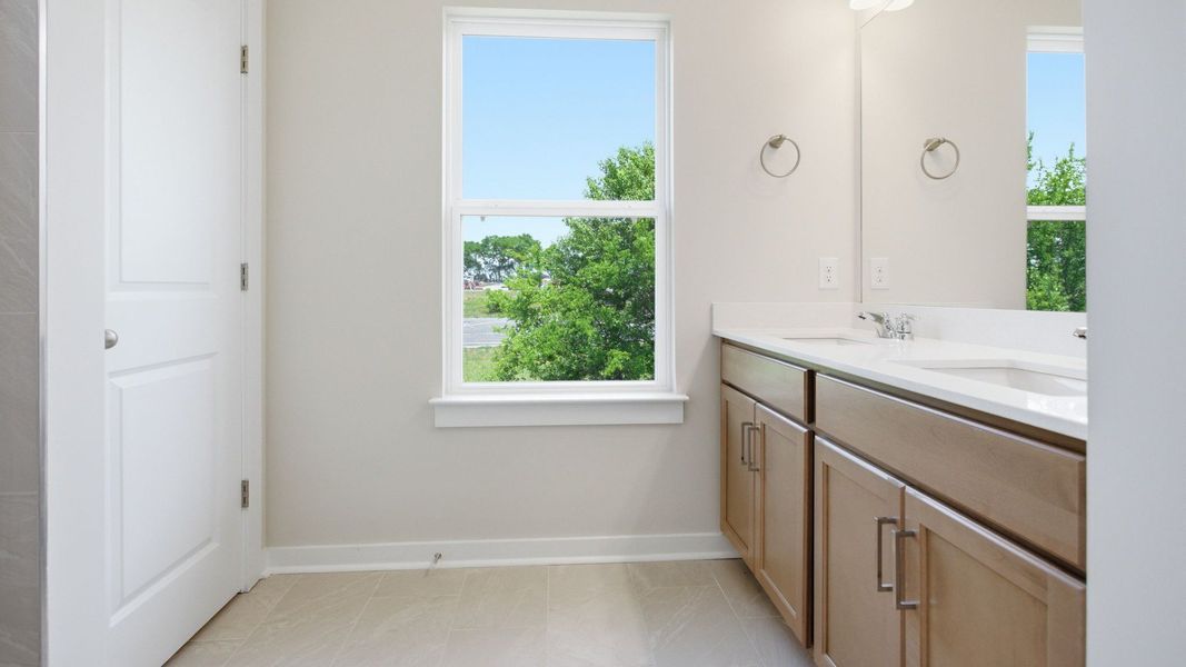 Bathroom with window, double vanity, and hard surface flooring Bathroom with window, double vanity, and hard surface flooring