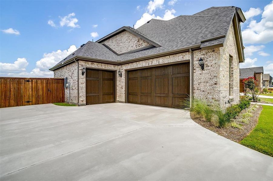 View of side of property with a garage