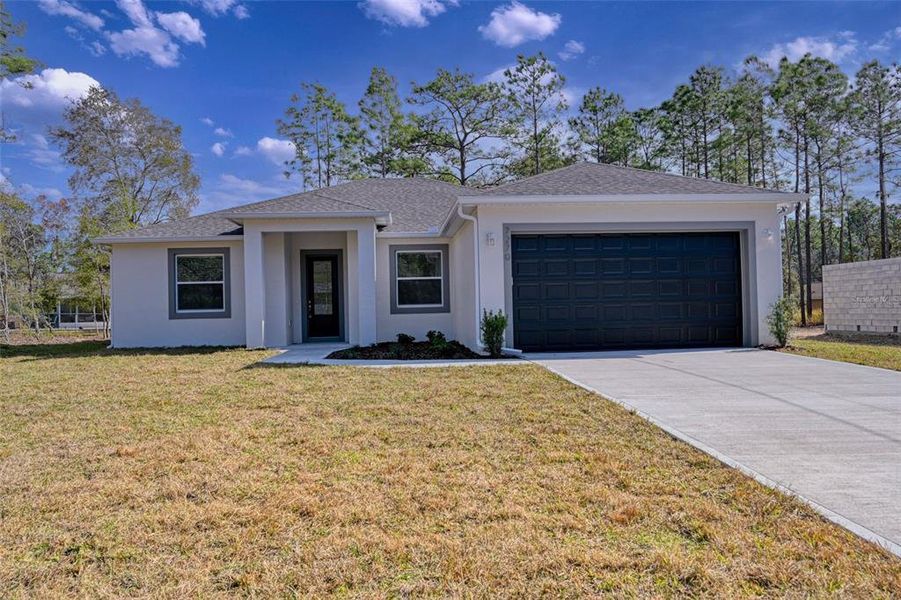 Front exterior of a new home in , Palm Bay, FL, highlighting curb appeal (Image 1). Front exterior of a new home in , Palm Bay, FL, highlighting curb appeal (Image 1).