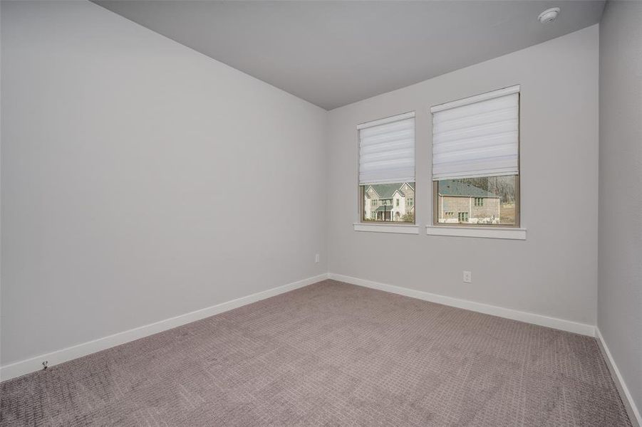 Unfurnished room with carpet and baseboards